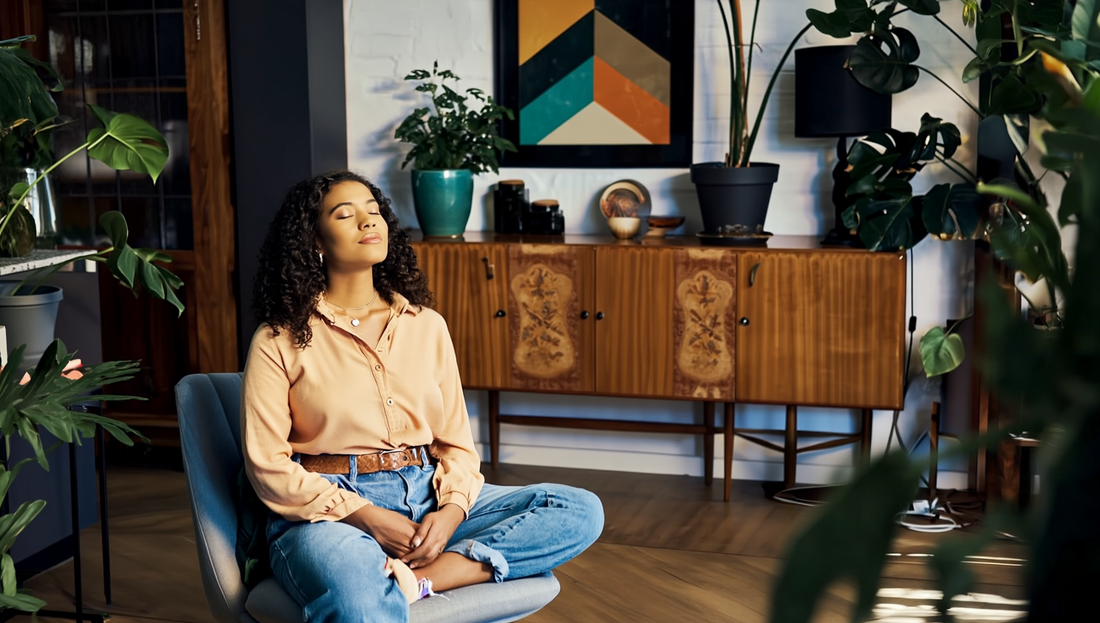A woman sits peacefully in her home